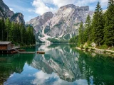 Alpine lake in Europe surrounded by forest and rocky peaks